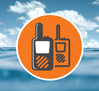 a man wearing a lifejacket holds a portable emergency beacon in his right hand and signals the number two with his left hand